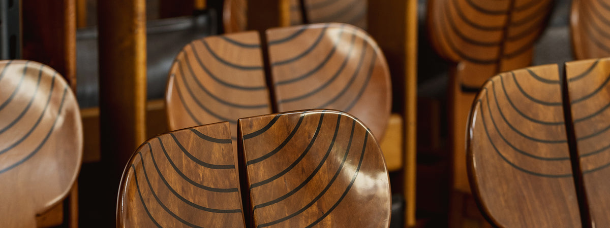 Wooden chairs with a wavy pattern in an indoor setting