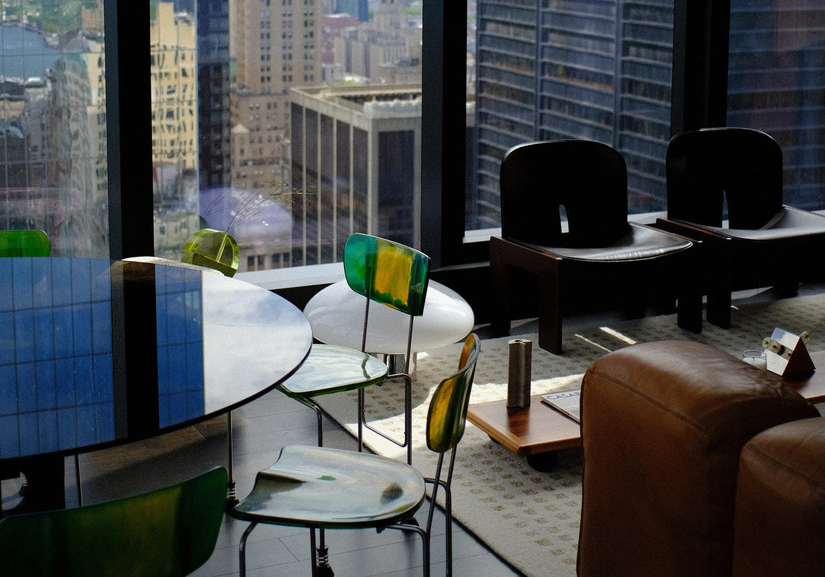 Modern office space with large windows offering a cityscape view.