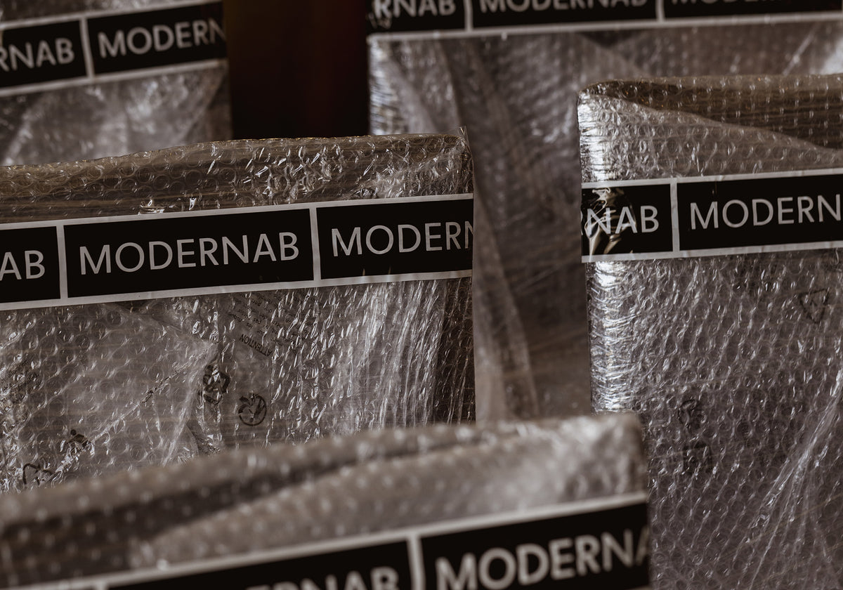 Stack of books with 'MODERNAB' labels on a textured surface