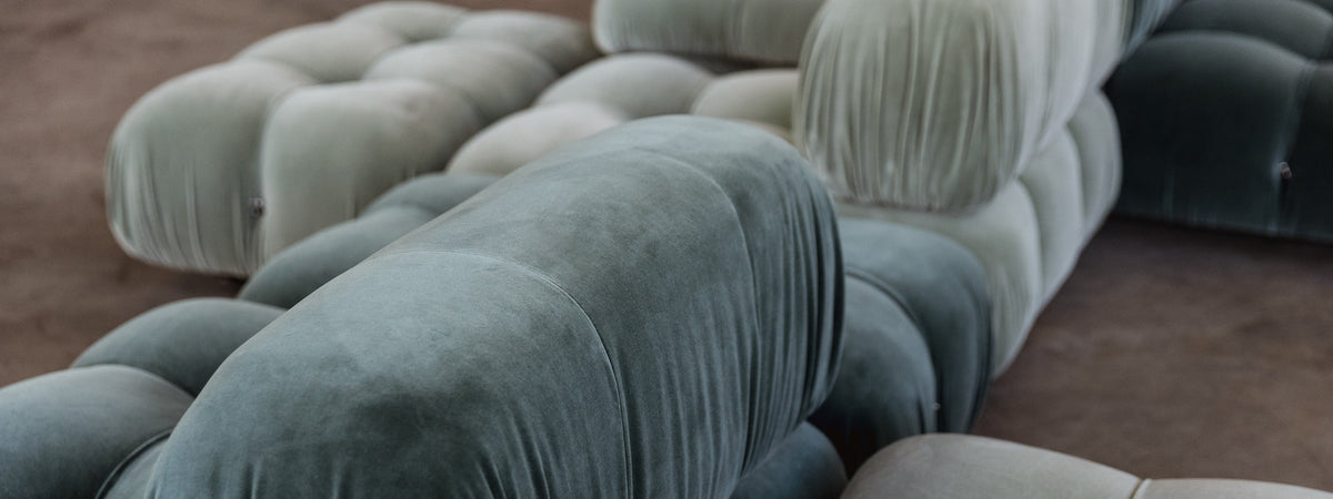 Section of a textured sofa with a neutral color palette on a blurred background