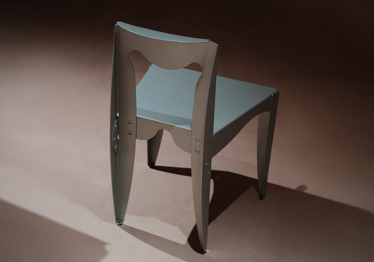 Libertà chair with a geometric design on a dark background